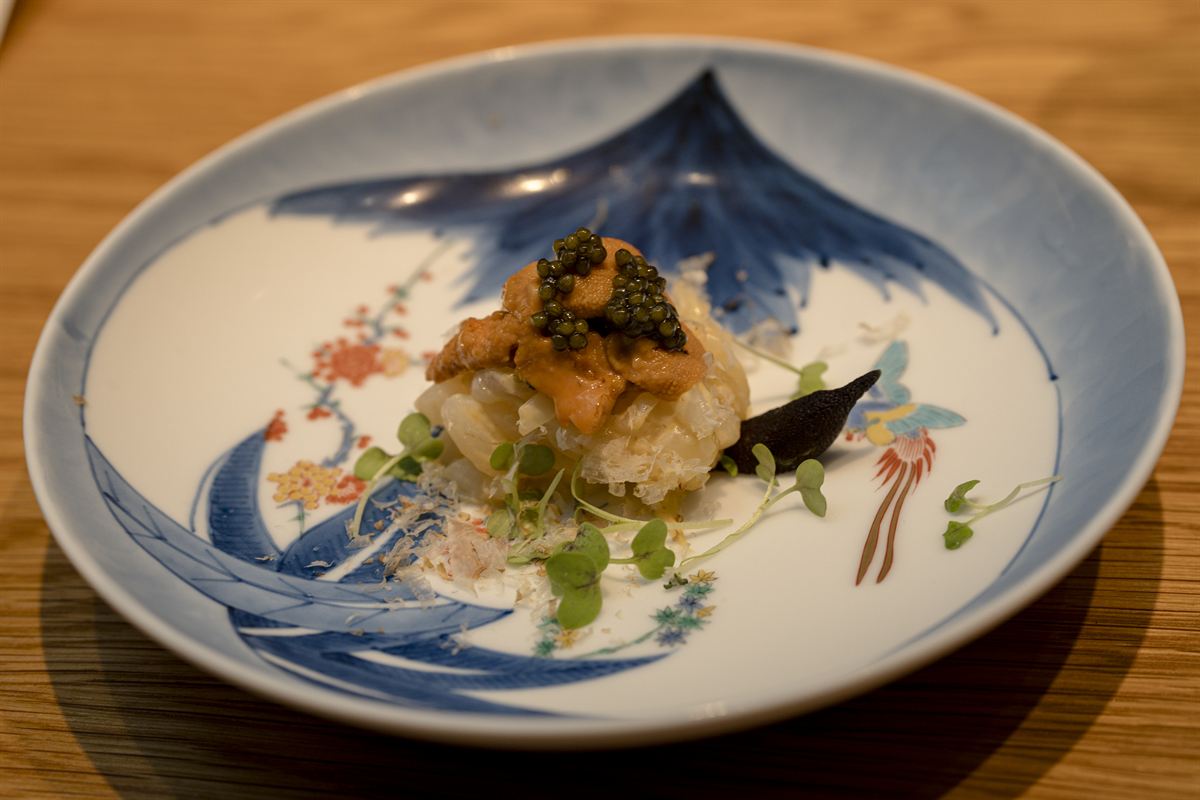 Uni and caviar over rice on a blue-and-white porcelain dish.